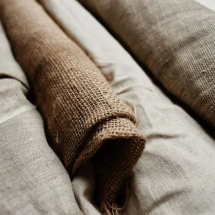 Stacks Of Neatly Folded Cotton Cloth Rolls In A Textile Warehouse